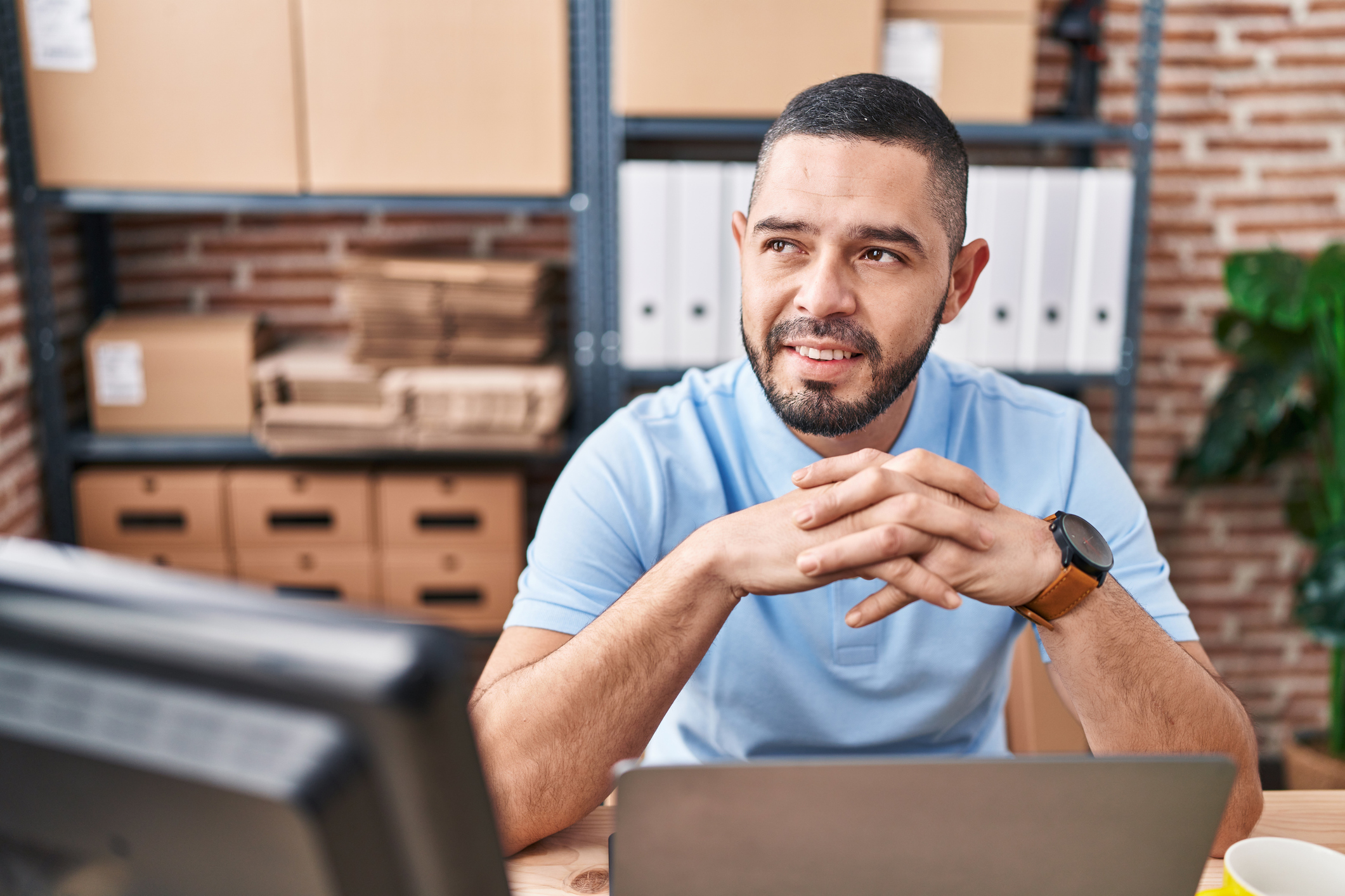Young latin man ecommerce business worker smiling confident using laptop at office Cloud Based Avada Finance